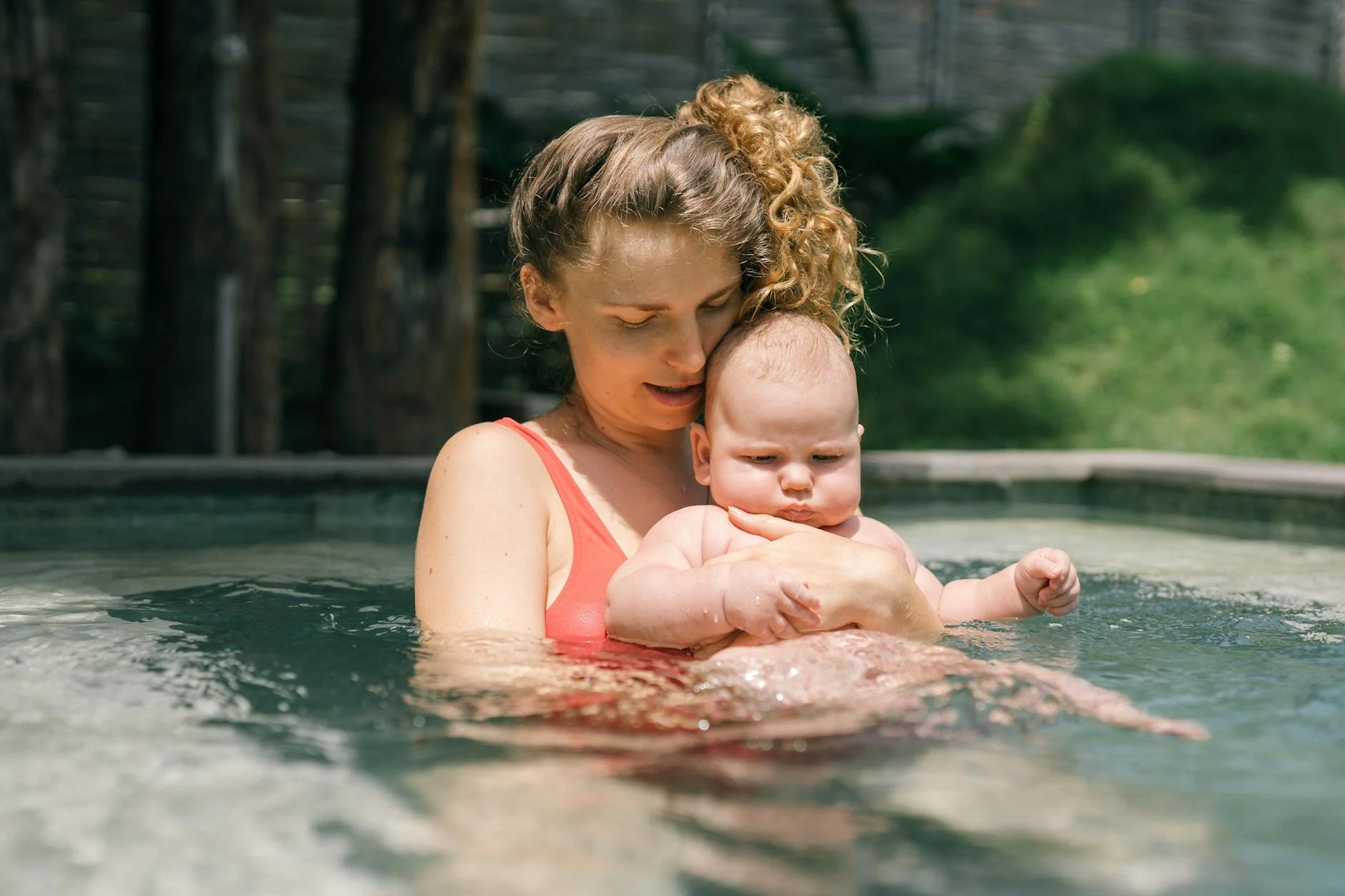 Mom holding her baby in the pool